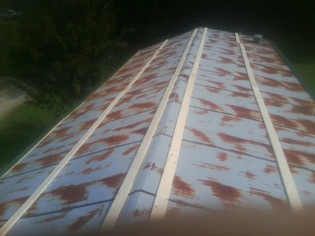 Rusted metal roof panels with new wood purlins before replacement — Storm Damage Roof Repair in San Mateo by Roofing Brothers