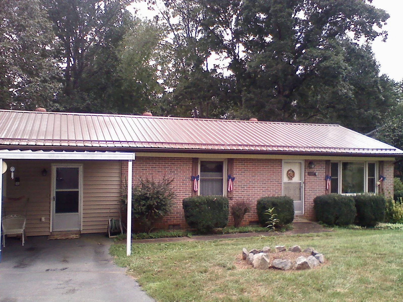 Bronze metal roof and carport on a brick ranch home — Roof Repair work by our crew in San Mateo